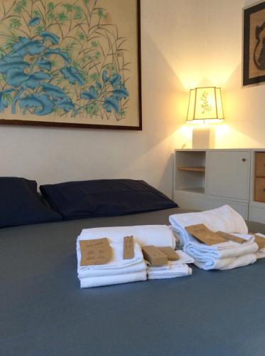 a room with a bed with towels on a table at La Casa di Renata by PortofinoVacanze in Rapallo
