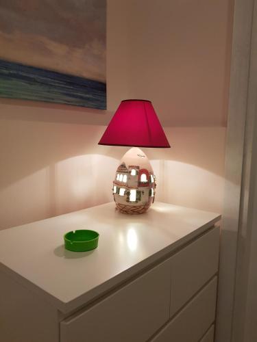 a lamp sitting on top of a dresser at GISELLE in Naples