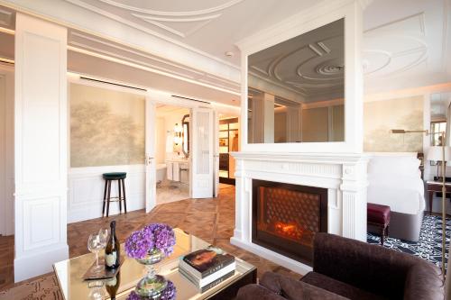 a living room with a fireplace and a bed at BLESS Hotel Madrid - The Leading Hotels of the World in Madrid