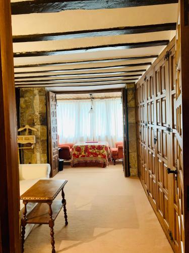 a living room with a bed and a table at Posada La Torre de La Quintana in Liendo