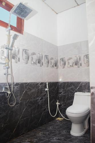 a bathroom with a shower and a toilet at Avendra Villa in Unawatuna