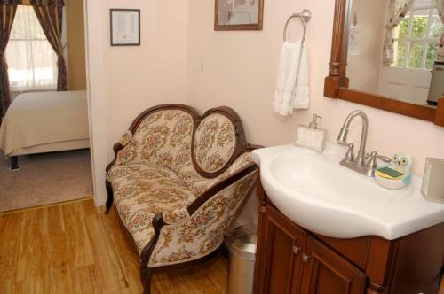 ein Badezimmer mit einem Waschbecken, einem Spiegel und einem Waschbecken in der Unterkunft Quaint Historic Downtown Apartment in St. Augustine