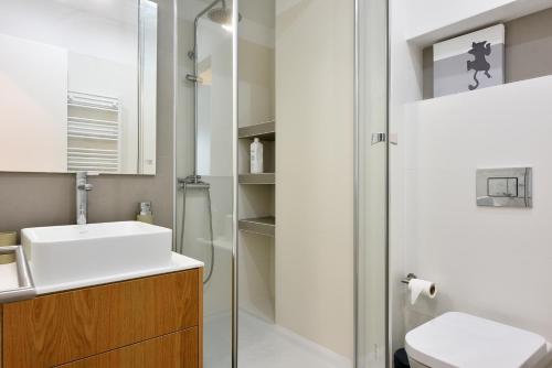 a bathroom with a sink and a toilet and a shower at Maestro Apartment by Trip2Portugal in Figueira da Foz