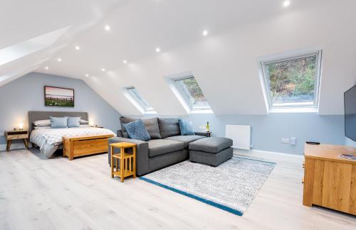 a living room with a bed and a couch at Rothbury Hideaway in Rothbury