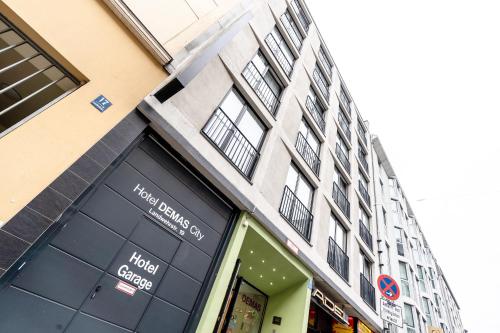 a store front of a building with black doors and windows at Hotel Demas City in Munich