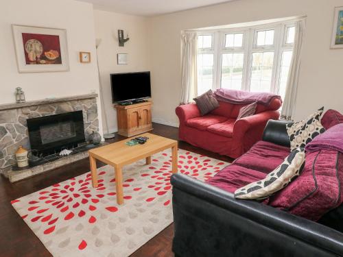 a living room with a couch and a fireplace at The Old Bakehouse in Llantwit Major