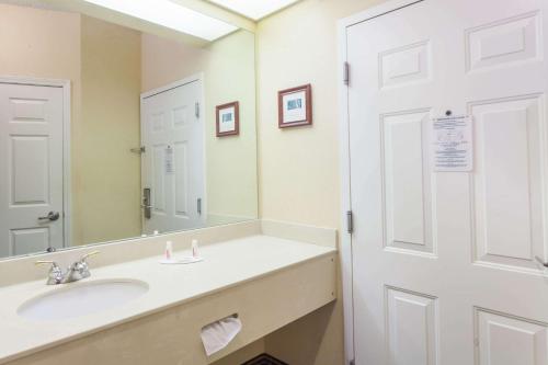 a bathroom with a sink and a mirror at Baymont by Wyndham Columbia Maury in Columbia