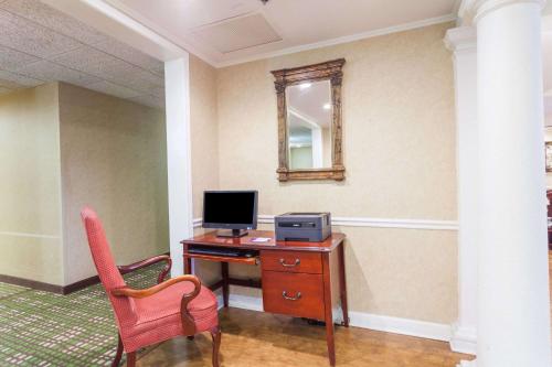 a room with a desk with a computer and a mirror at Baymont by Wyndham Columbia Maury in Columbia