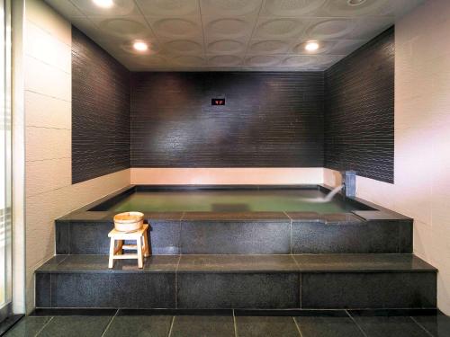a pool in a room with a stool in it at Ibis Ambassador Suwon in Suwon