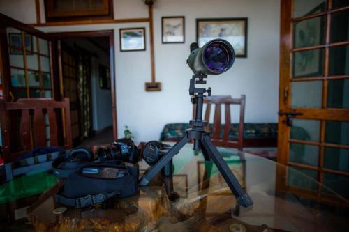 a camera on a tripod in a room at The Rangers Lodge, Imran's Jungle Home in Corbett in Rāmnagar