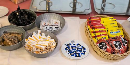a table topped with bowls of food and snacks at Gran Hotel Victoria in El Ejido