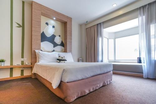 a bedroom with a large bed and a large window at The 5 Elements Hotel Chinatown Kuala Lumpur in Kuala Lumpur
