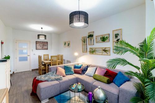 a living room with a couch and a table at My Granada Garden - Apartamento Orquídea in Granada