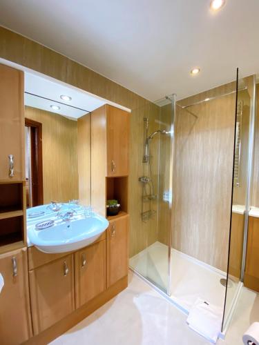 a bathroom with a sink and a shower at Cairngorm Guest House in Aviemore