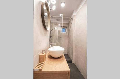 a bathroom with a white sink and a mirror at Briana Luxury Sky View Studio in Cluj-Napoca