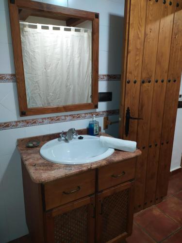 a bathroom with a sink and a mirror at Apartamentos Rurales Peralta in Segura de la Sierra
