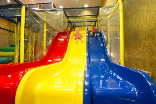 a group of children riding down a colorful slide at Toila Spa Hotel in Toila