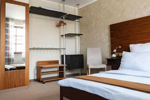 Ένα ή περισσότερα κρεβάτια σε δωμάτιο στο AKZENT Hotel Laupheimer Hof