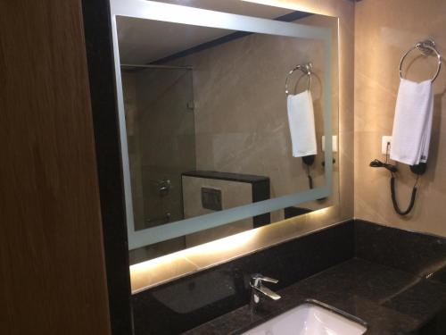 a bathroom with a sink with a mirror and a mirror at Comfort Inn in Lucknow