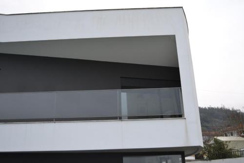 a building with a large window on the side of it at Casa do Mouro in Lousã