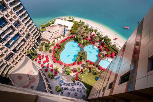 an aerial view of a resort with a pool and a beach at Khalidiya Palace Rayhaan by Rotana, Abu Dhabi in Abu Dhabi