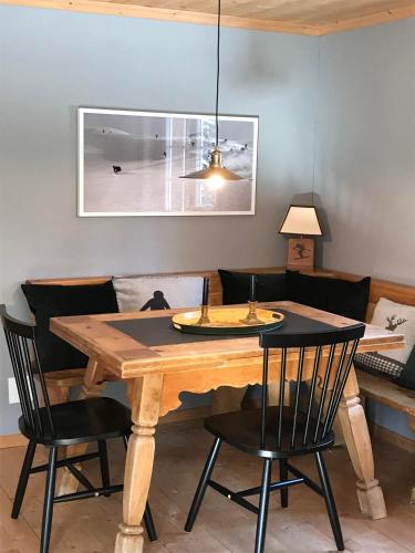 a dining room with a wooden table and chairs at Berghaus Alpenrösli in Klosters