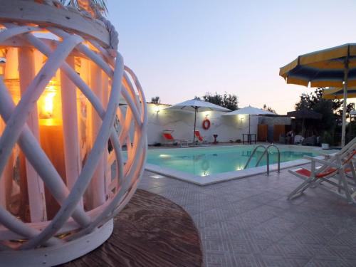 a swimming pool with a ball in front of it at Zia Pia in Locogrande