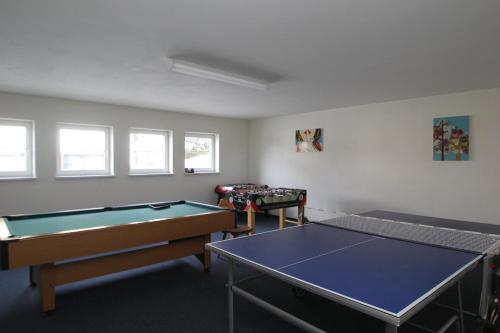 a room with two ping pong tables in it at Wander- und Familienhotel Erika in Wagrain