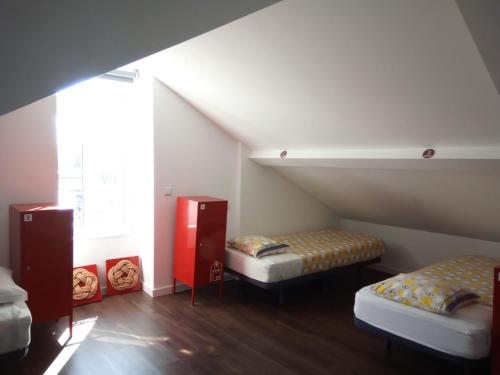 a attic room with two beds and a window at Aveiro Rossio Hostel in Aveiro