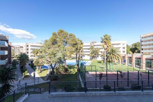 a view of a park with palm trees and buildings at Saval Spa Aqquaria Family Complex in Salou