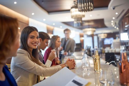 a group of people sitting at a bar at Hotel Centar No.1 in Belgrade