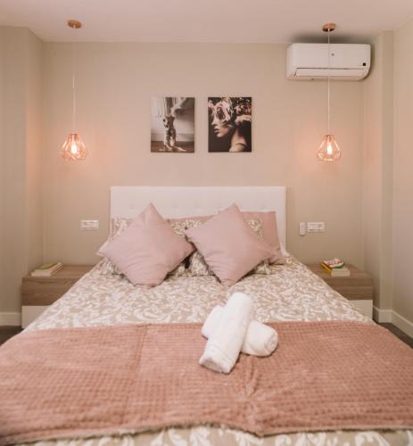 a bedroom with a bed with a stuffed animal on it at Las Coloradas in Torre del Mar