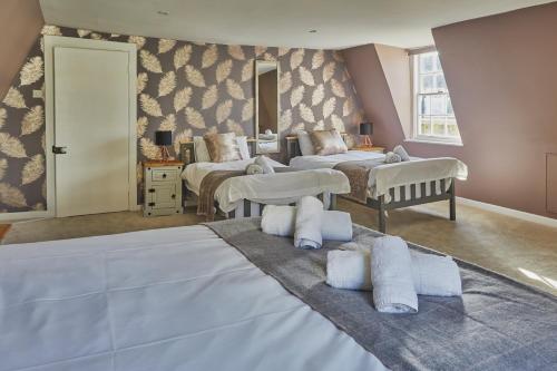 a bedroom with two beds and a room with two beds at Opposite to Sally Lunn's Spacious Luxury Maisonette! in Bath