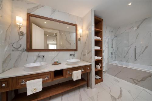 a bathroom with two sinks and a large mirror at Royal Blue Hotel in Dubrovnik