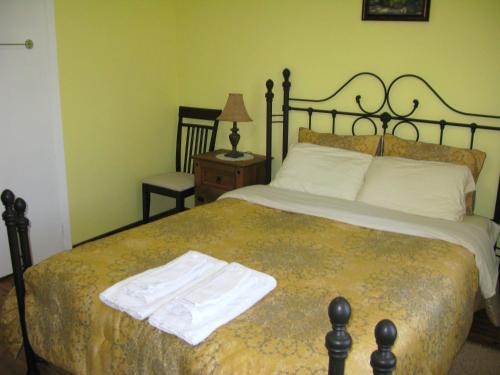 a bedroom with a bed with a towel on it at Gîte Aux Traditions in Saint-Jean-des Piles