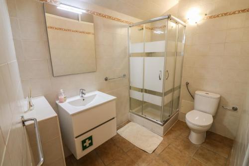 a bathroom with a shower and a toilet and a sink at Casa Algarvia in Lagos