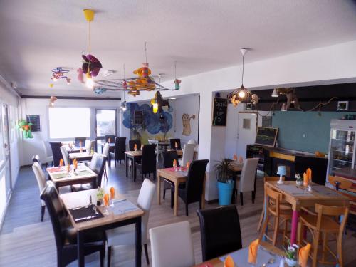 a dining room with tables and chairs in a restaurant at NESTOR HOTEL GAP et Restaurant in Gap