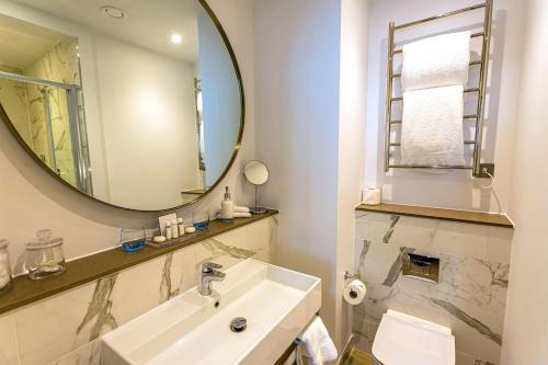 a bathroom with two sinks and a mirror at Southampton Harbour Hotel & Spa in Southampton