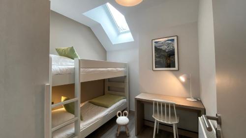 a small room with bunk beds and a desk at Le Génépy - Appart'hôtel de Charme in Chamonix