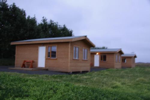 a couple of tiny homes in a field at Cabin 1 at Lundar Farm in Varmaland