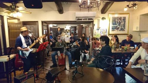 a group of people sitting in a restaurant playing instruments at Live Cafe Hisui no Umi in Itoigawa