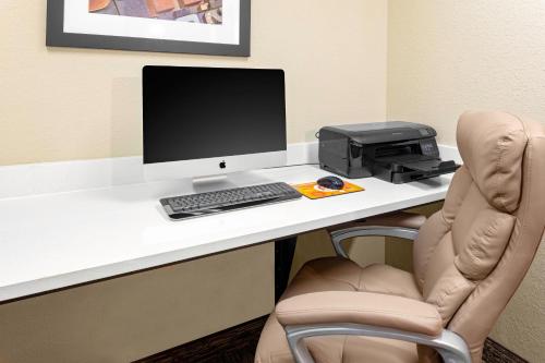 a desk with a computer monitor and a printer at Candlewood Suites Warner Robins by IHG in Warner Robins