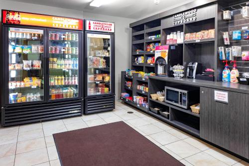 a store with a grocery store aisle with food and drinks at Candlewood Suites Warner Robins by IHG in Warner Robins