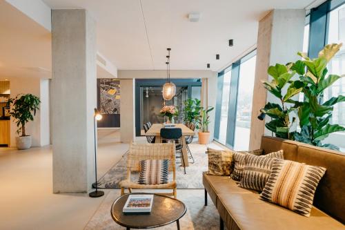 a living room filled with furniture and a large window at YAYS Amsterdam Docklands in Amsterdam