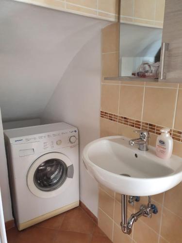a bathroom with a washing machine and a sink at Il Borgo Apartment in Gaeta