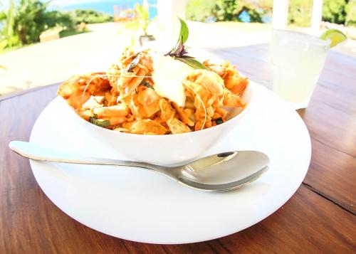 a bowl of food on a table with a spoon at Sky Island Resort in Ponta Malongane
