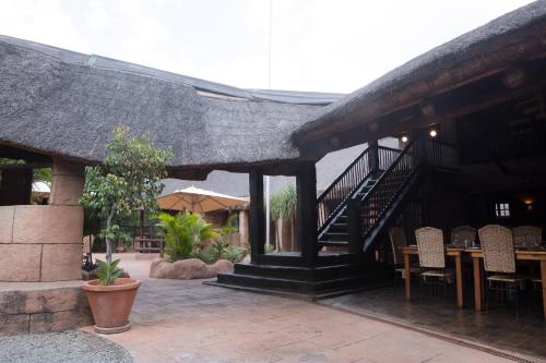 a building with a staircase and a table and chairs at Zebra Nature Reserve in Cullinan