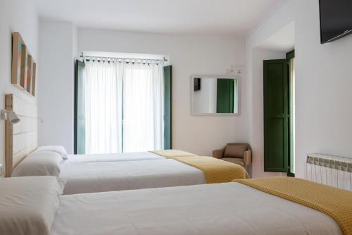 Postel nebo postele na pokoji v ubytování Hotel 3 Arcs