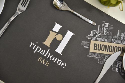 a table topped with a book with the word hiltonushima rate at Ripahome B&B in Ripalimosani
