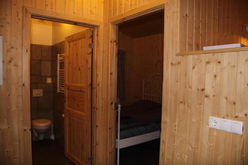 a bathroom with a door open to a room with a toilet at Cabin 1 at Lundar Farm in Borgarnes
